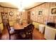 Elegant dining room with hardwood floors, stylish wallpaper, a classic chandelier, and a charming china cabinet at 6412 Fall Creek Rd, Indianapolis, IN 46220
