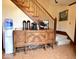 Welcoming entryway featuring wood stairs, a charming buffet table, and a refreshing water cooler station at 6412 Fall Creek Rd, Indianapolis, IN 46220