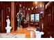 Elegant foyer with exquisite wood paneling, beautiful artwork, and stately decor, creating a luxurious ambiance at 6412 Fall Creek Rd, Indianapolis, IN 46220