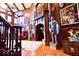 Impressive foyer showcasing a grand staircase, rich wood paneling, elegant decor, and a regal ambiance at 6412 Fall Creek Rd, Indianapolis, IN 46220