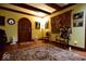 Grand foyer entrance with arched doorway, wood trim, decorative rug, and unique decor at 6412 Fall Creek Rd, Indianapolis, IN 46220