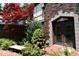 Arched entry with brick facade and beautifully landscaped yard, offering a timeless and elegant welcome at 6412 Fall Creek Rd, Indianapolis, IN 46220