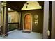 Inviting front porch featuring detailed woodwork, arched entryway, and decorative door at 6412 Fall Creek Rd, Indianapolis, IN 46220