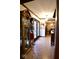 Hallway with decorative tile floor, antique clock, and view into the dining room at 6412 Fall Creek Rd, Indianapolis, IN 46220