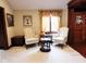 Cozy living room featuring classic decor, comfortable seating, and a large window with elegant curtains at 6412 Fall Creek Rd, Indianapolis, IN 46220