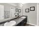 Bathroom with dual sinks, gray countertops, framed mirrors, and modern décor at 6645 Honeysuckle Way, Pendleton, IN 46064