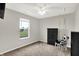 Cozy bedroom with gray walls, ceiling fan, and large window with an exterior view at 6645 Honeysuckle Way, Pendleton, IN 46064
