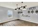 Modern dining room showcasing stylish lighting, decor, and wood flooring at 6645 Honeysuckle Way, Pendleton, IN 46064