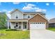 Charming two-story home featuring a brick facade and inviting front porch at 6645 Honeysuckle Way, Pendleton, IN 46064