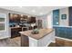 Modern kitchen features a granite island, stainless steel appliances, and dark wood cabinets at 6645 Honeysuckle Way, Pendleton, IN 46064