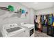 Functional laundry room equipped with modern washer, dryer, and ample storage at 6645 Honeysuckle Way, Pendleton, IN 46064