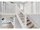 Bright carpeted staircase with white railings and views to lower level at 6645 Honeysuckle Way, Pendleton, IN 46064