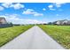 A long street extends into a residential neighborhood on a bright sunny day with a blue sky at 6645 Honeysuckle Way, Pendleton, IN 46064