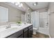 Well-lit bathroom featuring a double sink vanity, tub/shower combo, and stylish botanical decor at 6923 Bryant Pl, Plainfield, IN 46168