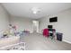 Bright bedroom with a ceiling fan, featuring neutral walls, plush carpet, and an entertainment center at 6923 Bryant Pl, Plainfield, IN 46168