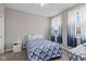 Cozy bedroom featuring neutral walls, bright windows with curtains, and a comfortable bed at 6923 Bryant Pl, Plainfield, IN 46168
