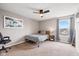 Bedroom featuring carpet, a ceiling fan, and a window showcasing neighborhood views and blue curtains at 6923 Bryant Pl, Plainfield, IN 46168