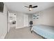 Cozy bedroom with blue bedding, an office chair, and view into the living room at 6923 Bryant Pl, Plainfield, IN 46168