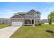Charming two-story home with a well-manicured lawn and a two-car garage at 6923 Bryant Pl, Plainfield, IN 46168