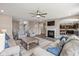 Open living room with fireplace, ceiling fan, and lots of seating for Gathering and friends at 6923 Bryant Pl, Plainfield, IN 46168