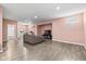 Spacious living room with a comfortable sofa, modern TV setup, and stylish wood-look flooring at 6923 Bryant Pl, Plainfield, IN 46168