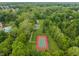 Expansive aerial view of tennis courts surrounded by verdant forest, offering a secluded recreational space at 7141 Ember Ct, Indianapolis, IN 46236