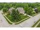 Aerial view of a suburban home with mature trees, landscaping, and an attached garage on a corner lot at 7141 Ember Ct, Indianapolis, IN 46236