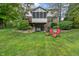 A spacious backyard featuring a patio, screened porch, and a well-maintained lawn with landscaping at 7141 Ember Ct, Indianapolis, IN 46236