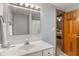 Well lit bathroom with vanity, sink, and mirror, as well as a view into the bedroom through an open door at 7141 Ember Ct, Indianapolis, IN 46236