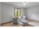 Bright bedroom featuring a ceiling fan, natural light, and two chairs at 7141 Ember Ct, Indianapolis, IN 46236
