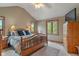 Cozy bedroom with wood furniture, vaulted ceiling, and ample natural light at 7141 Ember Ct, Indianapolis, IN 46236
