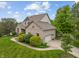 Beautiful brick house with well-manicured landscaping, driveway, and attached garage in a suburban neighborhood at 7141 Ember Ct, Indianapolis, IN 46236