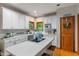 A spacious kitchen with white cabinets, an island cooktop, and hardwood floors at 7141 Ember Ct, Indianapolis, IN 46236