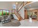 Inviting living room with high ceilings, large windows, and an open staircase at 7141 Ember Ct, Indianapolis, IN 46236