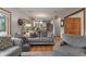 Spacious living room with hardwood floors and a view into the kitchen and backyard at 7141 Ember Ct, Indianapolis, IN 46236
