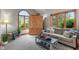 Comfortable living room featuring a cozy sofa, large windows, and ample natural light at 7141 Ember Ct, Indianapolis, IN 46236