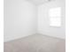 Simple, carpeted bedroom with a window for natural light and clean, white walls at 7431 Stillness Dr, Indianapolis, IN 46268