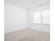 Bright, carpeted bedroom with two windows providing natural light and neutral tones throughout at 7431 Stillness Dr, Indianapolis, IN 46268