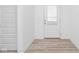 Inviting entryway with wood-look flooring, a white door with glass, and crisp, white walls at 7431 Stillness Dr, Indianapolis, IN 46268