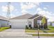 Charming single-story home with brick accents, a well-manicured lawn, and a two-car garage at 7431 Stillness Dr, Indianapolis, IN 46268