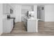 Modern kitchen with gray cabinets, stainless steel appliances, an island, and wood-look flooring at 7431 Stillness Dr, Indianapolis, IN 46268