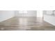 Open living room with stylish wood-look flooring, bright white walls, and abundant natural light at 7431 Stillness Dr, Indianapolis, IN 46268