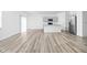 Spacious living area with wood-look floors, an island, and modern gray cabinets in the kitchen at 7431 Stillness Dr, Indianapolis, IN 46268