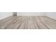Open-concept living space with wood-look floors and white walls creating a clean, modern feel at 7431 Stillness Dr, Indianapolis, IN 46268