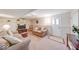 Spacious basement living area with comfortable seating, built-in shelving, and neutral decor for relaxation at 8120 Trevellian Way, Indianapolis, IN 46217