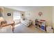 Bright bedroom with a window, a small desk, and a single bed adorned with toys and decorations at 8120 Trevellian Way, Indianapolis, IN 46217