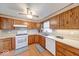 Well lit kitchen features wood cabinets and white countertops at 8120 Trevellian Way, Indianapolis, IN 46217