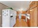 A kitchen featuring white appliances, wood cabinets, and wood floors at 8120 Trevellian Way, Indianapolis, IN 46217