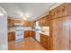 The kitchen offers classic wood cabinets and updated white appliances at 8120 Trevellian Way, Indianapolis, IN 46217