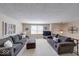 Spacious living area featuring neutral walls, comfortable seating, and ample natural light at 8120 Trevellian Way, Indianapolis, IN 46217